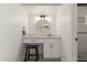 Bathroom vanity with a round mirror, stool, and modern fixtures at 2109 W El Alba Way, Chandler, AZ 85224