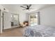 Bright bedroom featuring a ceiling fan, seating, and bathroom access at 2109 W El Alba Way, Chandler, AZ 85224