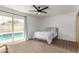Bedroom featuring a ceiling fan and glass doors leading to the outdoor pool at 2109 W El Alba Way, Chandler, AZ 85224