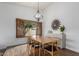 Elegant dining room featuring a wooden table set, modern lighting, and decorative accents at 2109 W El Alba Way, Chandler, AZ 85224