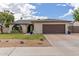 Charming single-story home with a well-maintained front yard and a two-car garage at 2109 W El Alba Way, Chandler, AZ 85224
