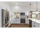 Modern kitchen featuring white cabinets, stainless steel appliances, and light countertops at 2109 W El Alba Way, Chandler, AZ 85224