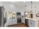 Updated kitchen with white cabinets, stainless appliances, and a view to the backyard at 2109 W El Alba Way, Chandler, AZ 85224