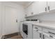 Modern laundry room equipped with appliances, ample counter space, and built-in cabinets at 2109 W El Alba Way, Chandler, AZ 85224
