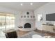 Bright living room with white stucco fireplace and hardwood floors leading to the outdoor patio at 2109 W El Alba Way, Chandler, AZ 85224