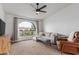 Cozy living area featuring neutral tones, comfortable seating, and an arched window with outdoor views at 2109 W El Alba Way, Chandler, AZ 85224