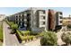 Modern apartment building showcasing unique architectural details and lush landscaping around the property at 2300 E Campbell Ave # 106, Phoenix, AZ 85016
