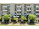 Contemporary apartment building featuring multiple floors, outdoor patios, and beautiful landscaping at 2300 E Campbell Ave # 106, Phoenix, AZ 85016