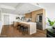 Modern kitchen featuring a large island, stainless steel appliances, and hardwood flooring at 2300 E Campbell Ave # 106, Phoenix, AZ 85016
