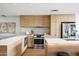 Modern kitchen with stainless steel appliances, a white countertop island, and wood cabinetry at 2300 E Campbell Ave # 106, Phoenix, AZ 85016