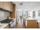 Modern kitchen with sleek appliances and center island that opens to a living area and outside patio at 2300 E Campbell Ave # 106, Phoenix, AZ 85016