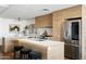 Modern kitchen featuring a large island with bar seating, stainless steel appliances, and wood accents at 2300 E Campbell Ave # 106, Phoenix, AZ 85016