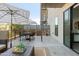 Serene outdoor patio with dining table, seating, and umbrella, ideal for alfresco dining and relaxation at 2300 E Campbell Ave # 106, Phoenix, AZ 85016