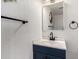 Well-lit bathroom with a navy vanity, black fixtures, and white walls at 2431 E Tracy Ln # 1, Phoenix, AZ 85032