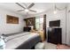 Bright bedroom with a ceiling fan, natural light, and framed art on the wall at 2431 E Tracy Ln # 1, Phoenix, AZ 85032