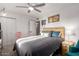 Bedroom showcasing neutral tones, ceiling fan, side tables, and natural lighting at 2431 E Tracy Ln # 1, Phoenix, AZ 85032