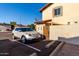 Exterior side of a home with private parking, a satellite dish, and a security gate at 2431 E Tracy Ln # 1, Phoenix, AZ 85032