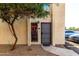 Cozy condo entrance with a security door, mature tree, and well-maintained desert landscaping at 2431 E Tracy Ln # 1, Phoenix, AZ 85032