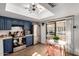 Well-lit kitchen featuring stainless steel appliances, blue cabinets, and a view to the patio at 2431 E Tracy Ln # 1, Phoenix, AZ 85032