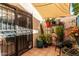 Private patio with potted plants, sun shade, and cozy seating area at 2431 E Tracy Ln # 1, Phoenix, AZ 85032