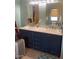 Bathroom vanity with double sink, marble countertop, and blue cabinets at 2637 S Amanda Dr, Maricopa, AZ 85139