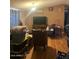 Living room with wood laminate flooring and a mounted television at 2637 S Amanda Dr, Maricopa, AZ 85139