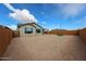 View of the home and spacious backyard with gravel landscaping at 27053 W Ponderosa Ln, Buckeye, AZ 85396