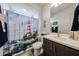 Well-lit bathroom with a tub, modern vanity, and nautical themed decor at 27053 W Ponderosa Ln, Buckeye, AZ 85396