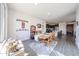 Bright dining room with wood floors, a table set for four, and an open view to the kitchen at 27053 W Ponderosa Ln, Buckeye, AZ 85396