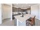 Elegant kitchen featuring an island with breakfast bar and stainless steel appliances at 27053 W Ponderosa Ln, Buckeye, AZ 85396