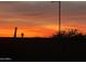 Fiery sunset scene showing the vivid orange and red sky overlooking the silhouette of the neighborhood at 27053 W Ponderosa Ln, Buckeye, AZ 85396