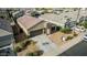 Aerial view of the home with a two-car garage, desert landscaping, and a tile roof at 30954 W Whitton Ave, Buckeye, AZ 85396