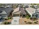 Bird's eye view of a home showcasing its tidy landscaping, tile roof and neighborhood setting at 30954 W Whitton Ave, Buckeye, AZ 85396