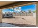 Spacious backyard with a trampoline, fire pit, and gravel at 30954 W Whitton Ave, Buckeye, AZ 85396