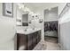 Bathroom features a double sink vanity with an adjacent walk-in closet at 30954 W Whitton Ave, Buckeye, AZ 85396