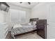 Well-lit bedroom featuring neutral paint, a comfortable bed, window, and dark wood furniture at 30954 W Whitton Ave, Buckeye, AZ 85396