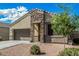 Charming single-Gathering home with a well-maintained yard and a welcoming stone facade entrance with a two-car garage at 30954 W Whitton Ave, Buckeye, AZ 85396