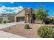 Charming single-Gathering home with a well-maintained yard and a welcoming stone facade entrance with a two-car garage at 30954 W Whitton Ave, Buckeye, AZ 85396