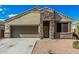 Charming single-Gathering home featuring a well-manicured front yard and a welcoming stone facade entrance and two-car garage at 30954 W Whitton Ave, Buckeye, AZ 85396