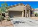 Charming single-Gathering home featuring a well-manicured front yard and a welcoming stone facade entrance and a two-car garage at 30954 W Whitton Ave, Buckeye, AZ 85396