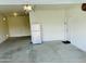 Spacious garage with room for parking and storage, featuring an included refrigerator and utility door at 30954 W Whitton Ave, Buckeye, AZ 85396