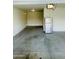 Spacious garage with concrete flooring and lots of potential, and featuring an included refrigerator at 30954 W Whitton Ave, Buckeye, AZ 85396