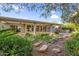 Backyard with rock lined garden, rock features, mature foliage and covered patio at 315 E Marlette Ave, Phoenix, AZ 85012