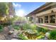 Landscaped backyard with pond and covered patio perfect for outdoor entertaining at 315 E Marlette Ave, Phoenix, AZ 85012