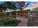 Covered patio that overlooks a pond with beautiful landscaping and a built-in outdoor grill at 315 E Marlette Ave, Phoenix, AZ 85012