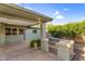 Patio and backyard featuring a built in BBQ and established trees and vegetation at 315 E Marlette Ave, Phoenix, AZ 85012