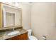 Elegant bathroom with granite countertop and wood cabinets. Bright and functional space at 315 E Marlette Ave, Phoenix, AZ 85012