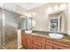 Updated bathroom featuring dual sinks, granite countertops, and a tiled glass shower at 315 E Marlette Ave, Phoenix, AZ 85012