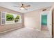 Sunlit bedroom with neutral walls and carpets, complemented by views of the outdoors at 315 E Marlette Ave, Phoenix, AZ 85012