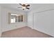 Comfortable bedroom featuring a ceiling fan, closet, and a large window with natural light at 315 E Marlette Ave, Phoenix, AZ 85012